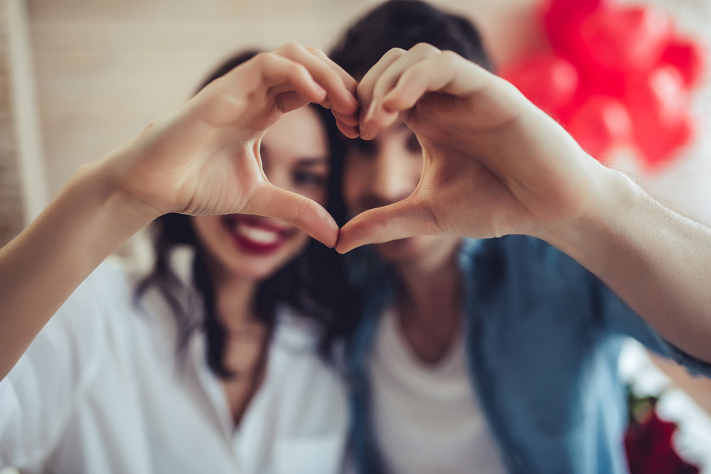 Feature image for this page `Find Your Perfect Match: The Best Latex Balloons for Valentine's Day Romance` showcasing a couple in front of Red Latex Balloons for Valentines Day. 